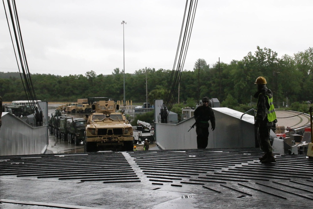 Soldiers and Marines load equipment aboard the U.S.N.S. Watkins (T-AKR 315) while moored at Wharf Alpha on Joint Base Charleston, South Carolina