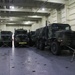 Soldiers and Marines load equipment aboard the U.S.N.S. Watkins (T-AKR 315) while moored at Wharf Alpha on Joint Base Charleston, South Carolina