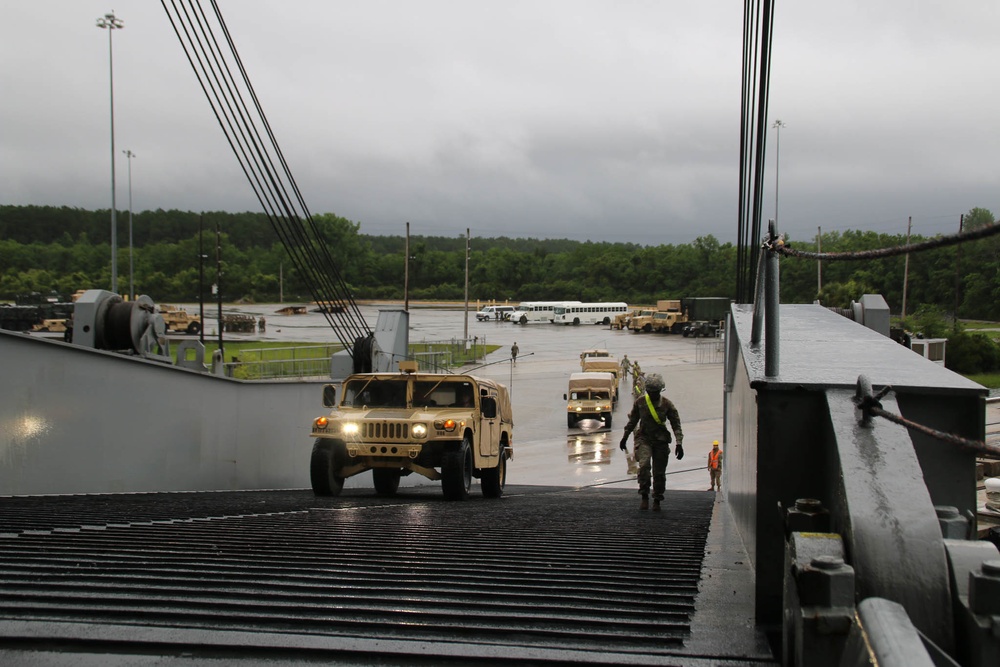 Soldiers and Marines load equipment aboard the U.S.N.S. Watkins (T-AKR 315) while moored at Wharf Alpha on Joint Base Charleston, South Carolina