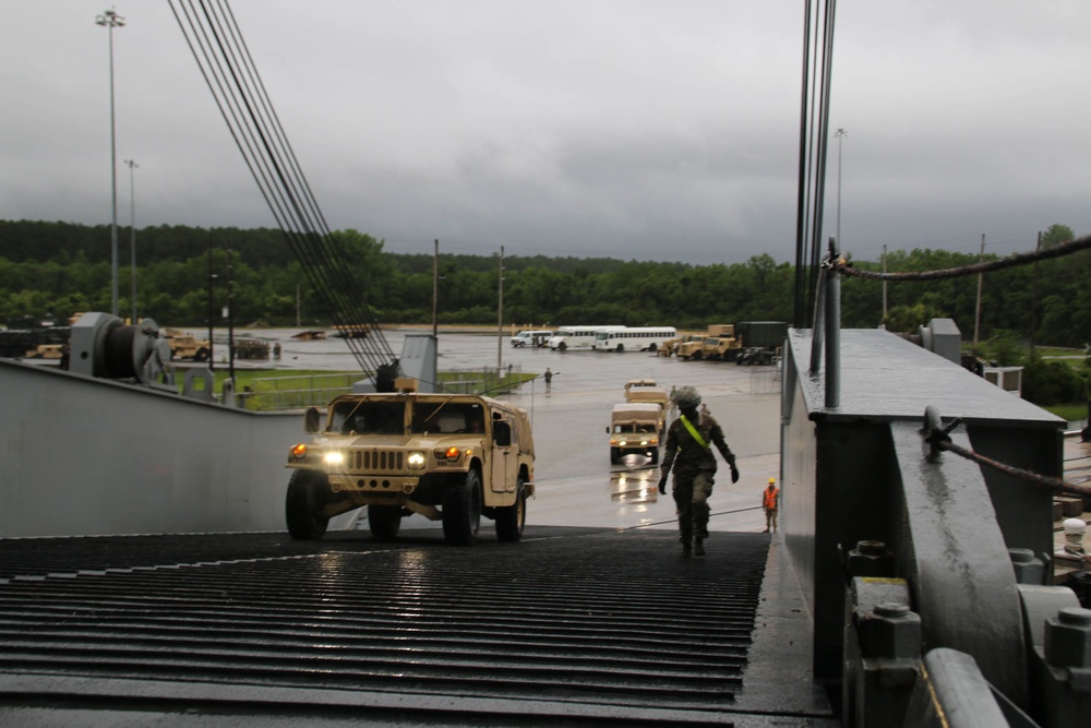 Soldiers and Marines load equipment aboard the U.S.N.S. Watkins (T-AKR 315) while moored at Wharf Alpha on Joint Base Charleston, South Carolina