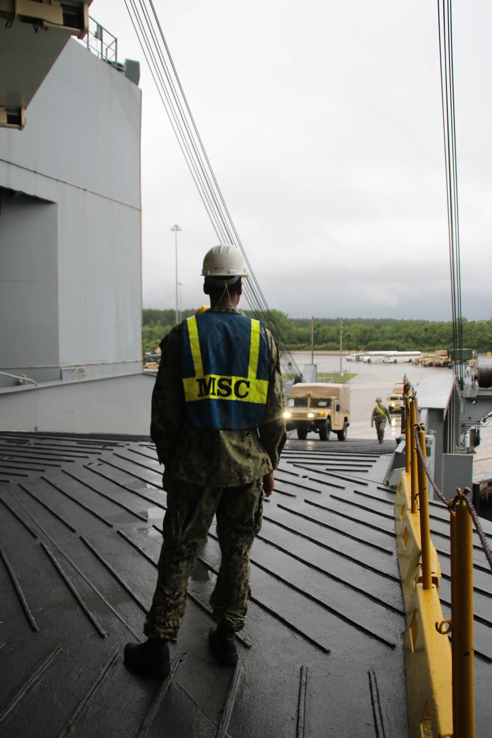 Soldiers and Marines load equipment aboard the U.S.N.S. Watkins (T-AKR 315) while moored at Wharf Alpha on Joint Base Charleston, South Carolina