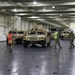 Soldiers and Marines load equipment aboard the U.S.N.S. Watkins (T-AKR 315) while moored at Wharf Alpha on Joint Base Charleston, South Carolina