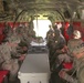 Soldiers rehearse safety procedures in a Chinook helicopter