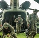 Soldiers exit a Chinook helicopter