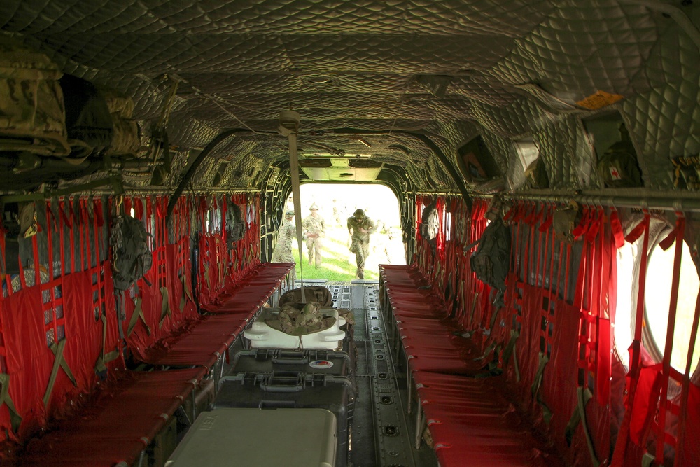 A soldier leads his soldiers onto a Chinook helicopter