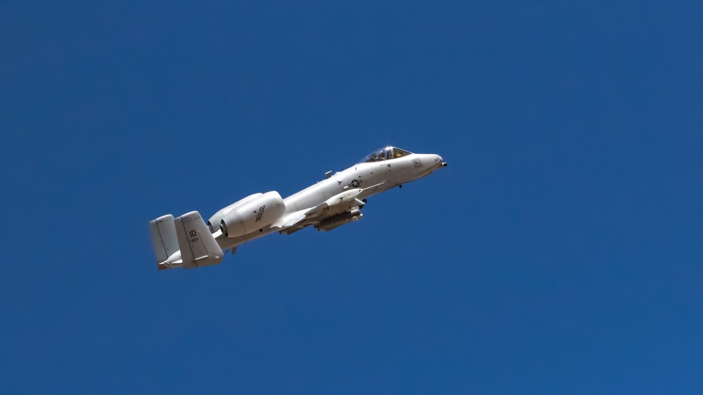 A-10 C Thunderbolt II flies over M1A2 Abrams at NTC