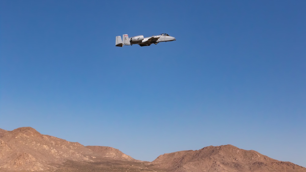 A-10 C Thunderbolt II flies over M1A2 Abrams at NTC