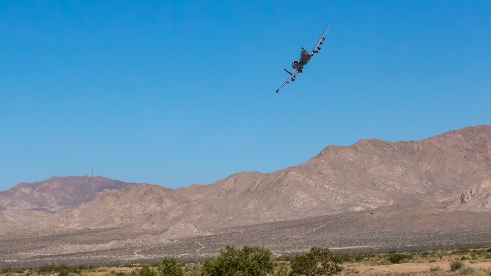 A-10 C Thunderbolt II flies over M1A2 Abrams at NTC