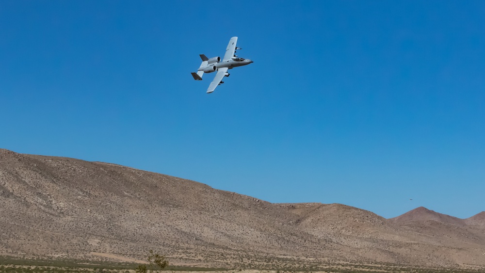 A-10 C Thunderbolt II flies over M1A2 Abrams at NTC