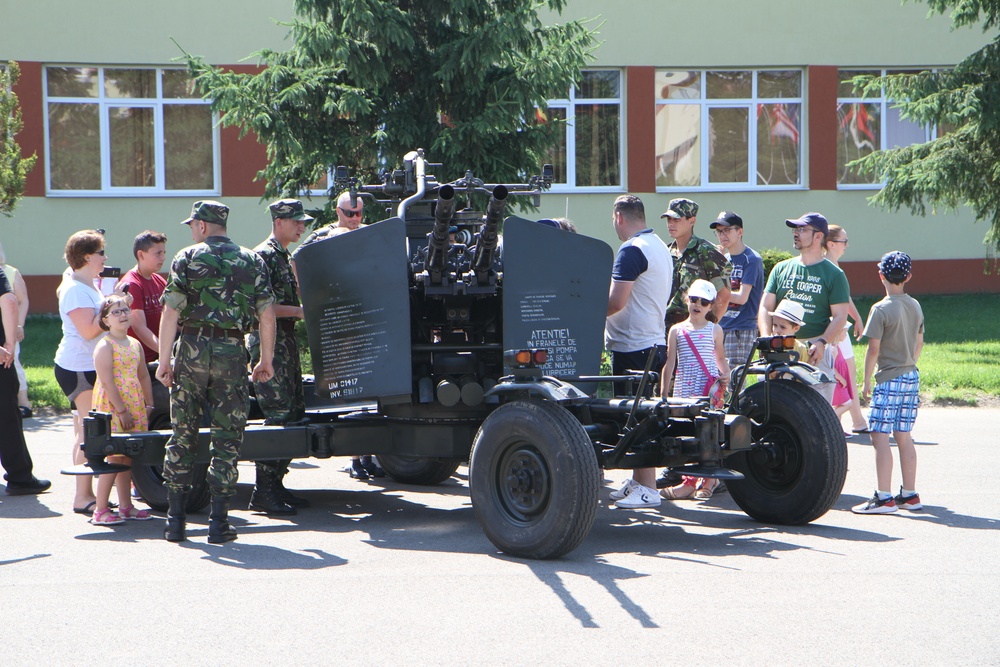 Romanian Soldiers and civilians in front of anti-aircraft gun at static display in Sibiu, Romania