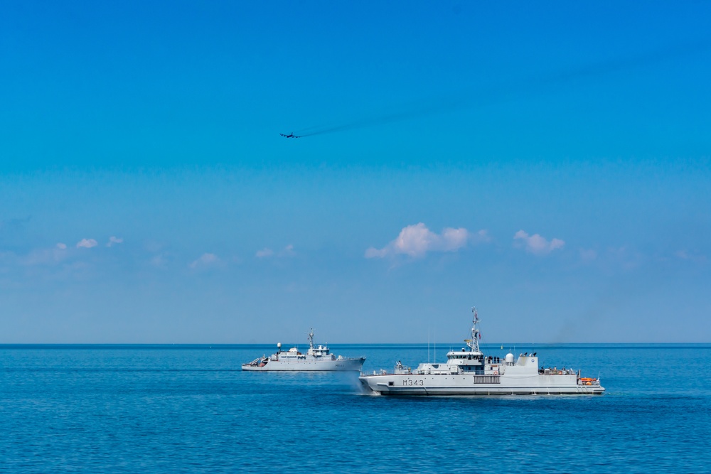 A B-52 Stratofortress flies over French Tripartite-class mine warfare ship FS Pegase (M644), left, and Norwegian Oskoy-class mine hunter HNoMS Hinnoy after dropping inert training mines during exercise Baltic Operations (BALTOPS) 2019