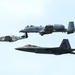 A F-22, A-10C, and P-51D fly in a formation at the Wings Over Whiteman Air and Space Show