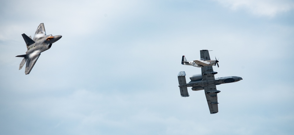 A U.S. Air Force F-22, A-10 and P-51 perform at the Wings Over Whiteman Air and Space show