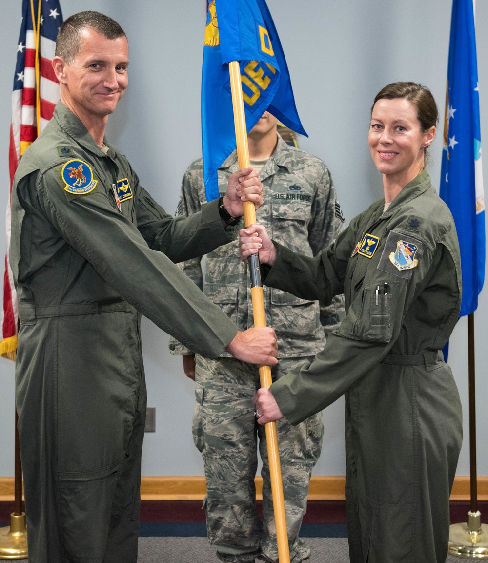 Lt. Col. Ian Cunningham gives the guidon to Lt. Col. Nicola Polidor during the 29th TSS Det 5 change of command ceremony