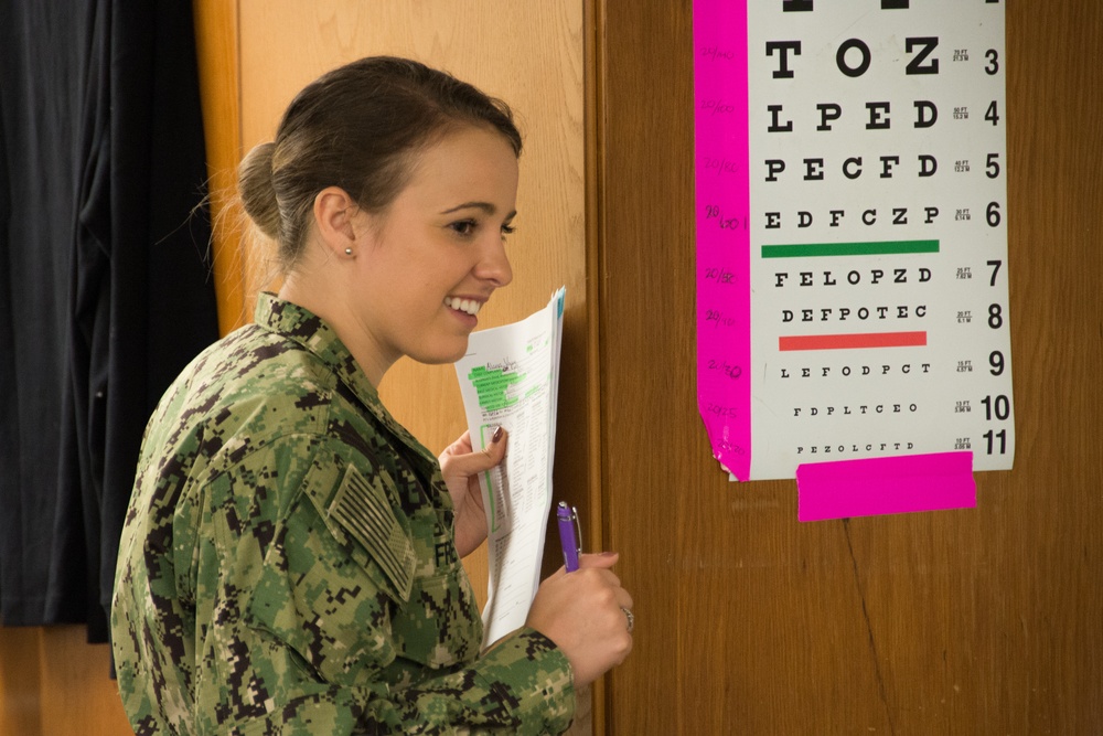Hospital Corpsman Tests Patients Eyesight Suring IRT Mission