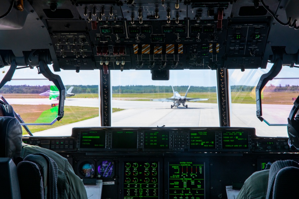 U.S. Marine Corps KC-130 Hercules refuel Canadian aircraft in the air