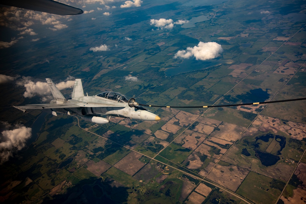 U.S. Marine Corps KC-130 Hercules refuel Canadian aircraft in the air