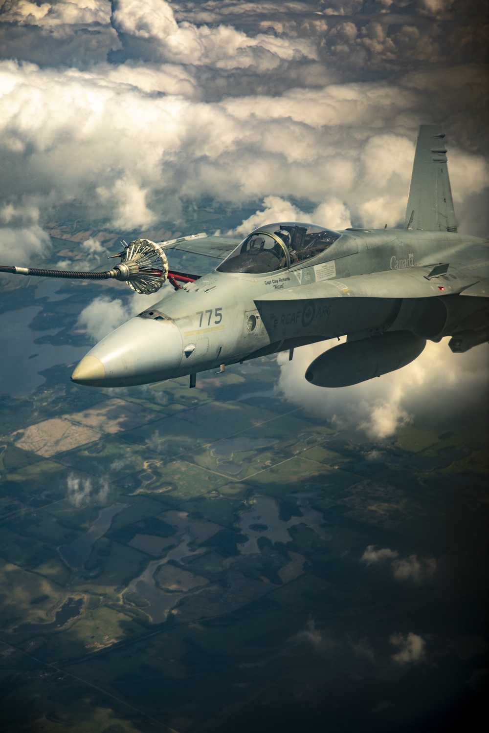 U.S. Marine Corps KC-130 Hercules refuel Canadian aircraft in the air