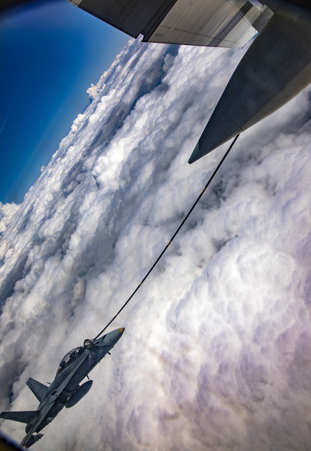 U.S. Marine Corps KC-130 Hercules refuel Canadian aircraft in the air