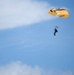 A U.S. Army Golden Knight team member glides towards the landing zone at the Wings Over Whiteman air show