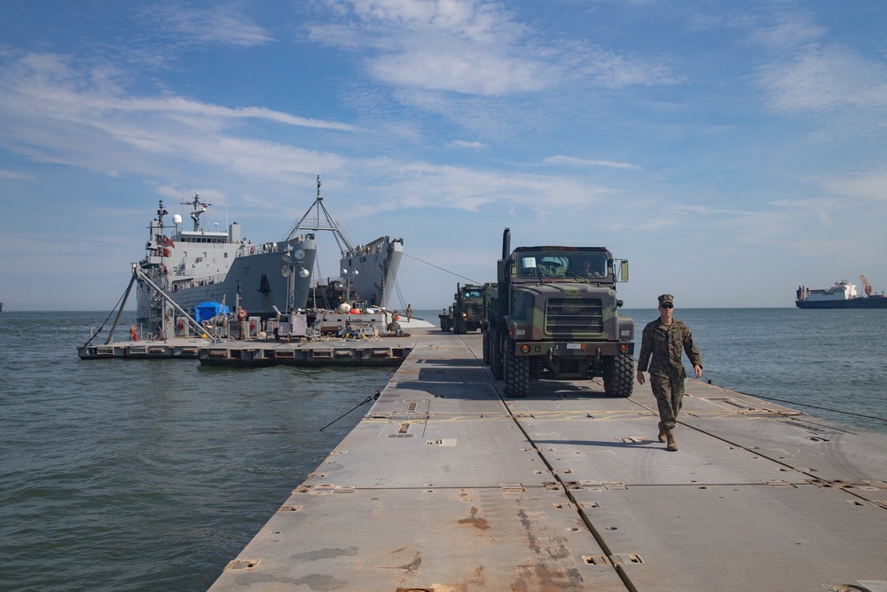 Marines with 2nd Transportation Support Battalion off Load Vehicles of a Trident Pier during Resolute Sun