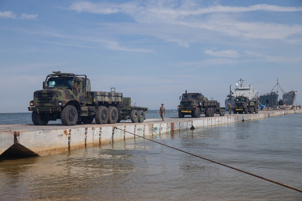 Marines with 2nd Transportation Support Battalion off Load Vehicles of a Trident Pier during Resolute Sun