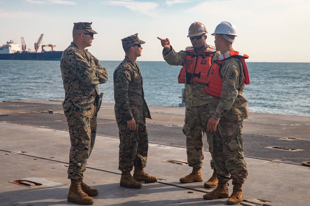 Marines with 2nd Transportation Support Battalion off Load Vehicles of a Trident Pier during Resolute Sun