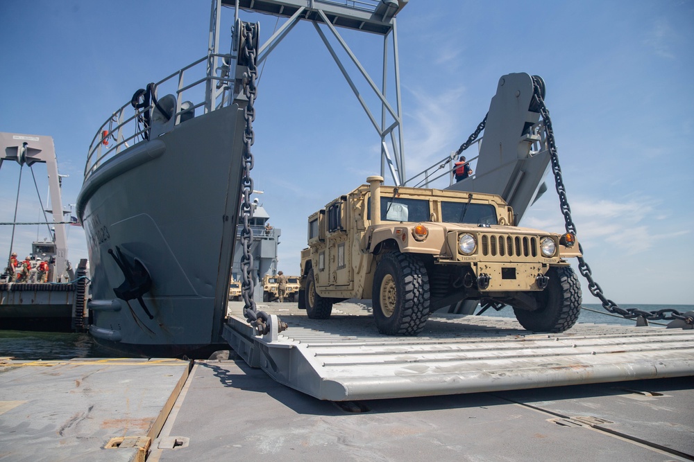 Marines with 2nd Transportation Support Battalion off Load Vehicles of a Trident Pier during Resolute Sun