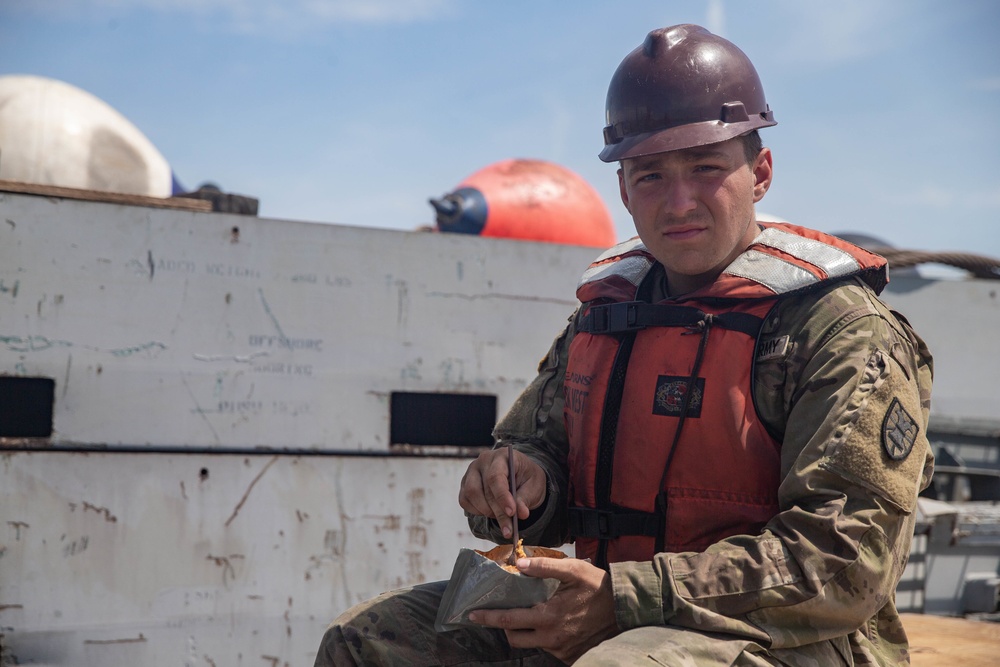 Marines with 2nd Transportation Support Battalion off Load Vehicles of a Trident Pier during Resolute Sun