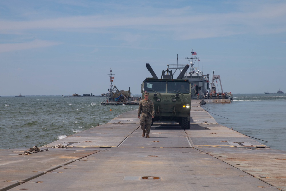 Marines with 2nd Transportation Support Battalion off Load Vehicles of a Trident Pier during Resolute Sun