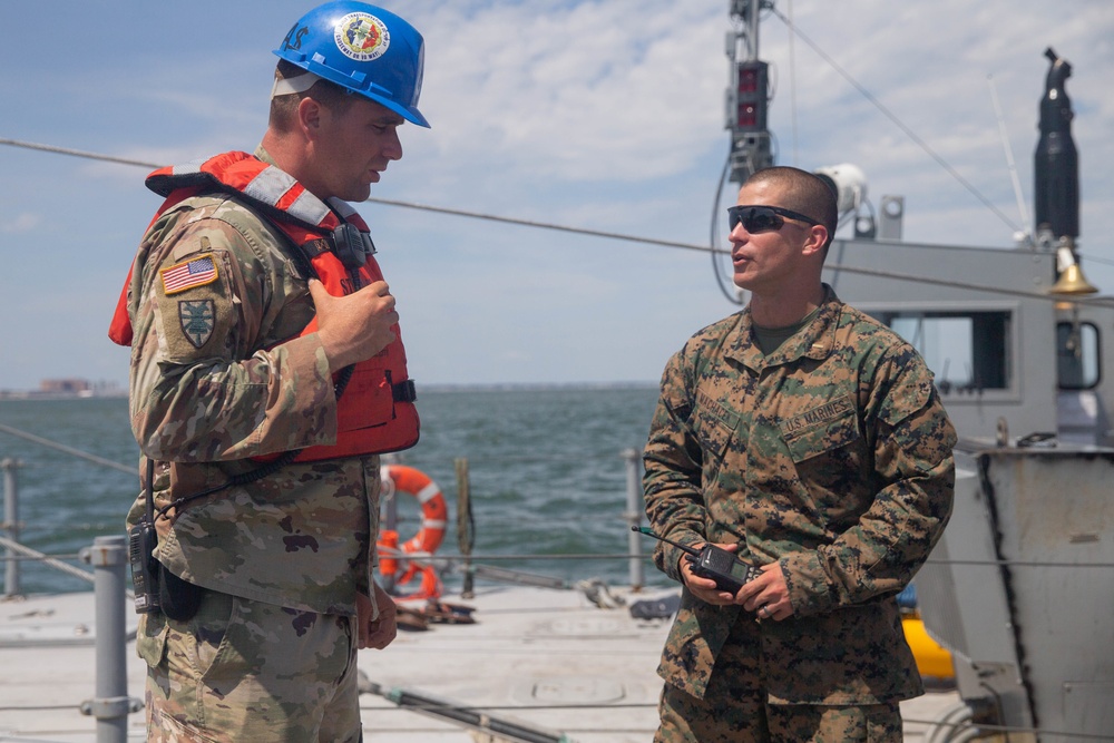 Marines with 2nd Transportation Support Vehicles off Load Vehicles of a Trident Pier during Resolute Sun