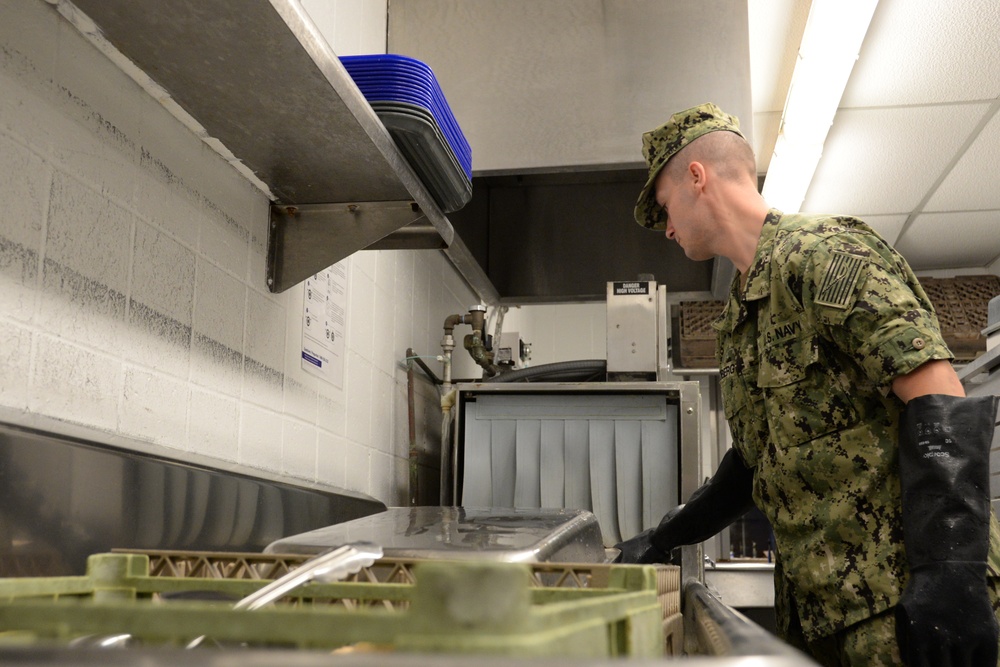 Navy Culinary Specialist Sanitizes Equipment