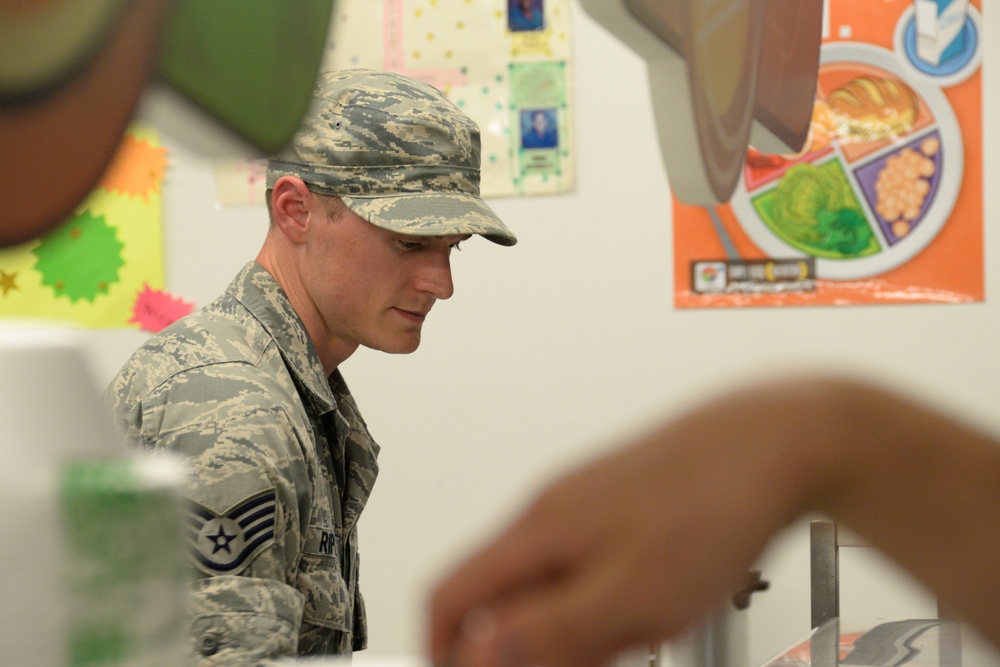 Services Specialist Serves Dinner During IRT Mission