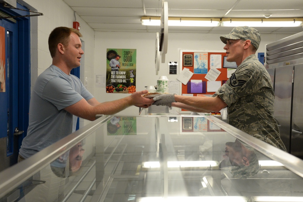 Services Specialist Serves Dinner During IRT Mission