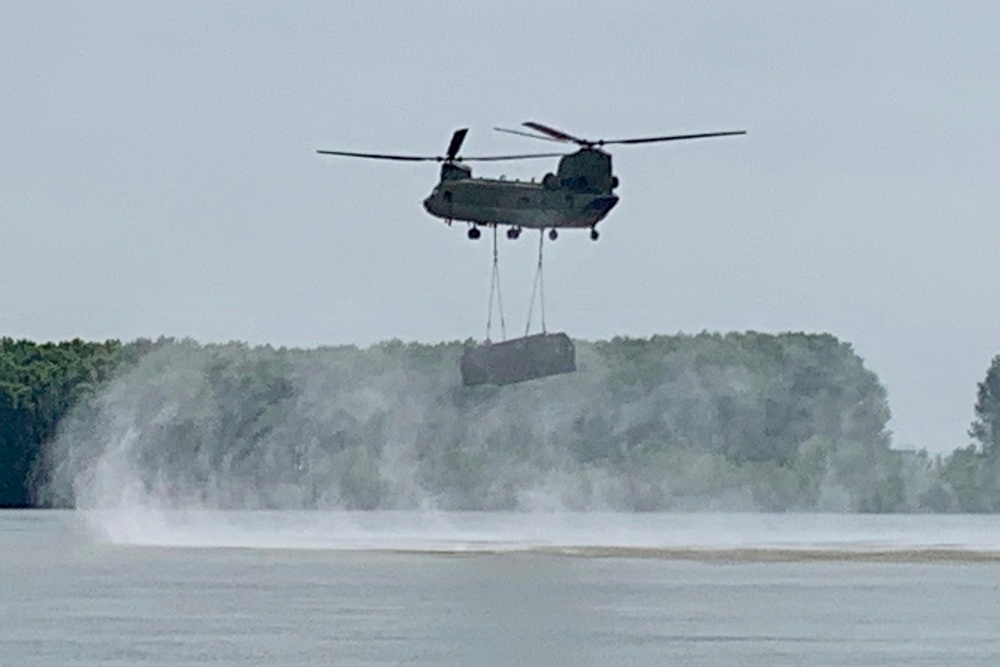 Chinook sling loads section of raft over Danube River