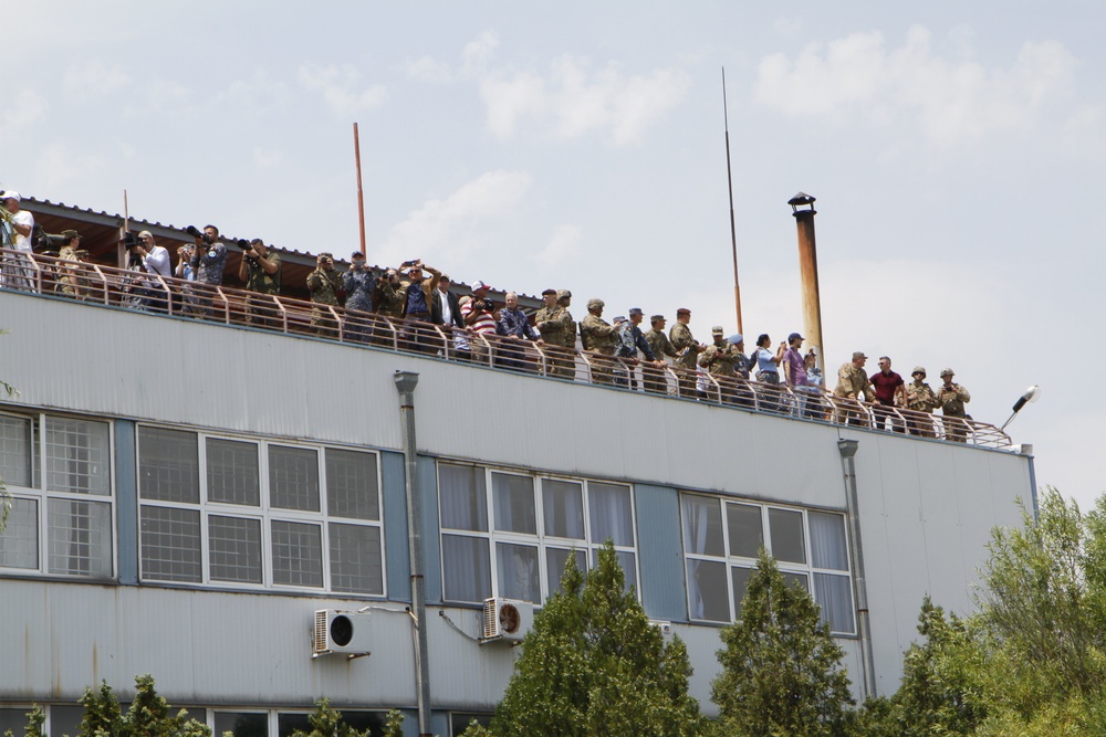 NATO's distinguished visitors and civilian media watch missiles fire during live fire display