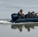 Romanian Soldiers maneuver an inflatable bombard raft across the Danube River