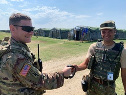 Col. Case, Commander of the 209th DLD receives gift from Romanian coalition partner at Saber Guardian