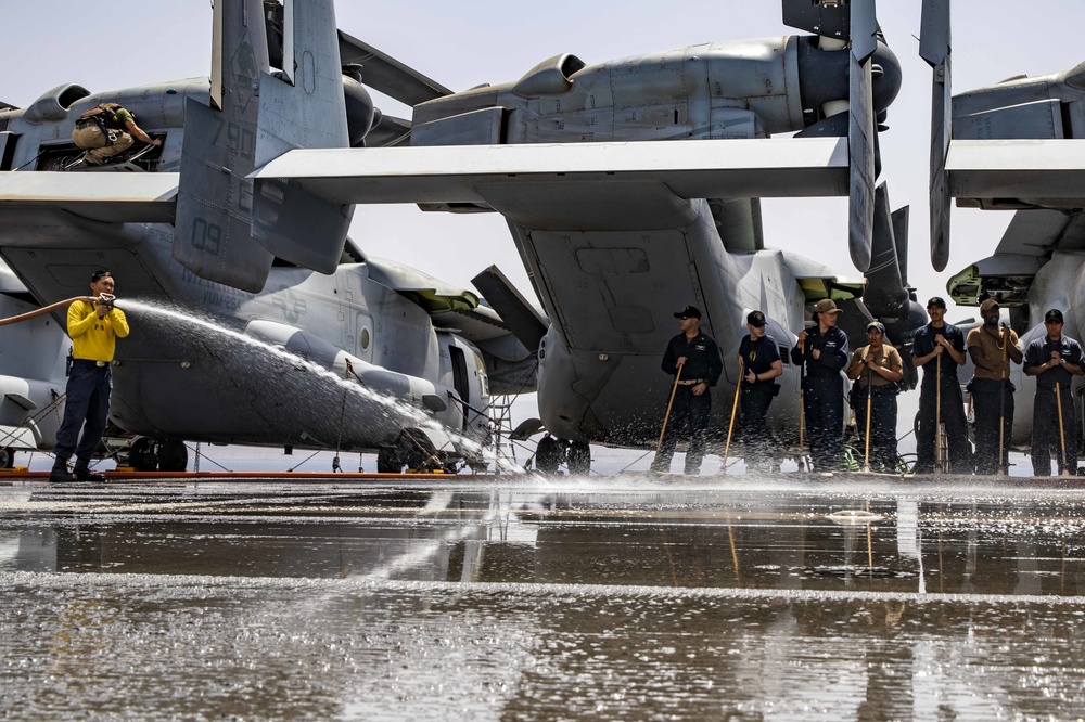 Aviation Boatswain's Mate (Handling) 2nd Class sprays water on the flight deck