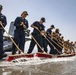 Sailors and Marines wash the flight deck