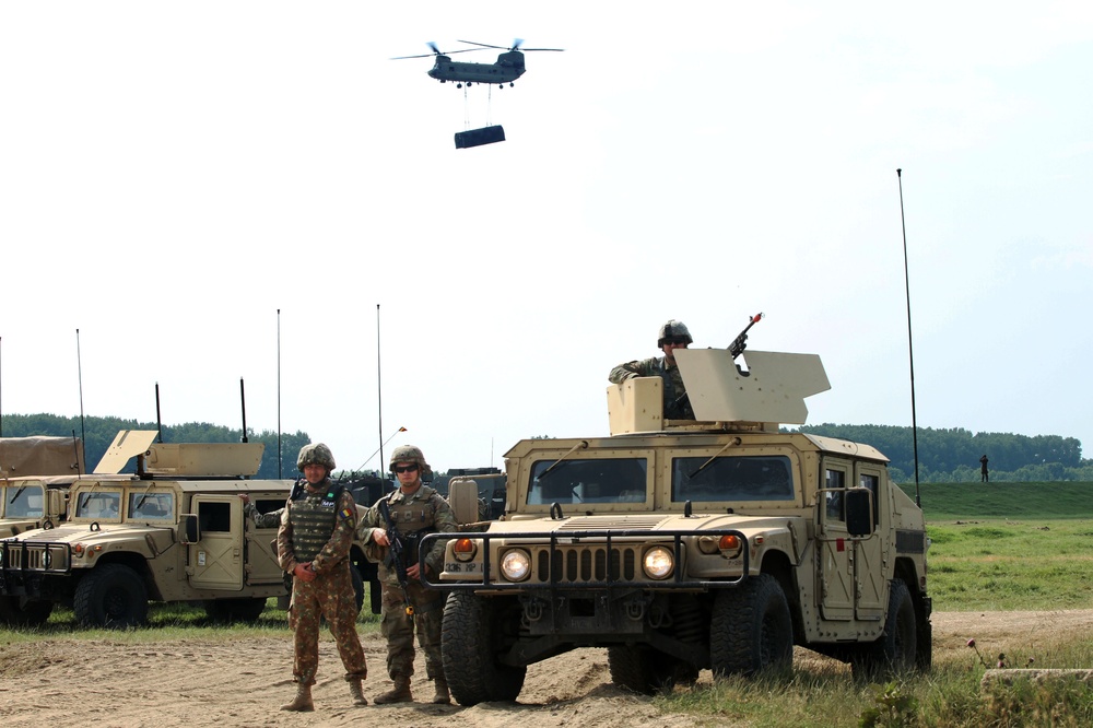 U.S. Army soldiers guard the traffic control point with soldiers from the Multinational Brigade during Saber Guardian 19