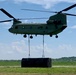 Chinook lifts raft for wet gap crossing exercise during Saber Guardian 19