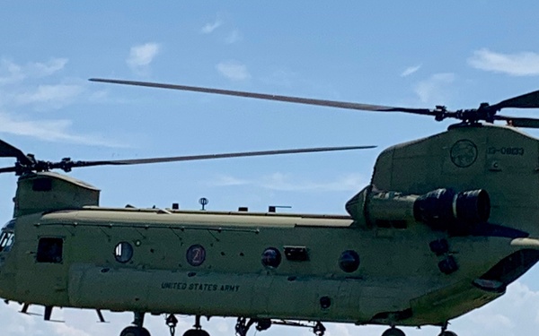 Soldiers finalize sling loading a raft