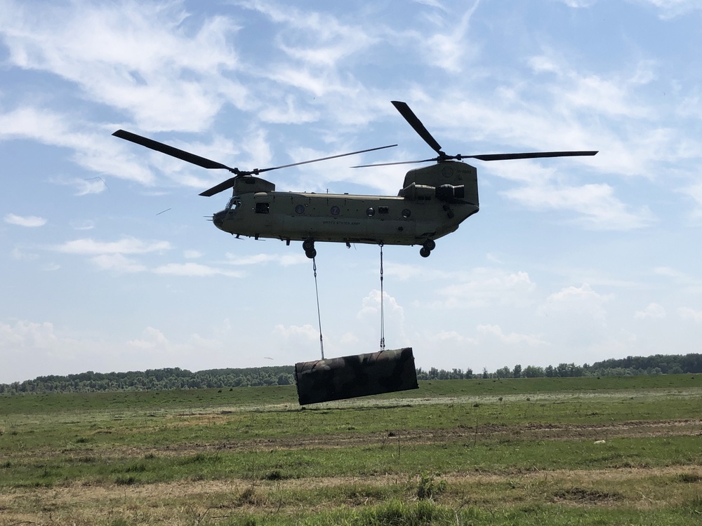 Chinooks conduct sling load operations