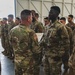 Col. Steven Pierce gives a 1CAB Soldier a certificate of Appreciation for participating in the full scale Garrison Exercise.