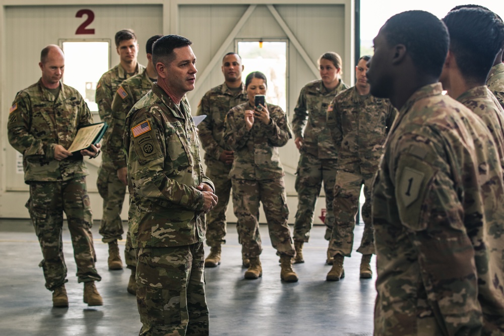 Col. Steven Pierce thanking several 1st Combat Aviation Brigade Soldiers