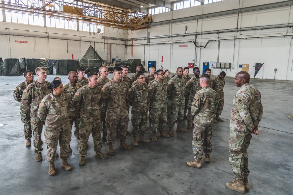 Col. Steven Pierce and CSM Philson Tavernier thanking several 1st Combat Aviation Brigade Soldiers