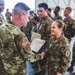 Col. Steven Pierce gives a 1CAB Soldier a certificate of Appreciation for participating in the full scale Garrison Exercise.