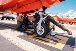 A student and instructor pilot perform preflight inspection before student's first flight