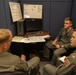Two Student pilots perform preflight NATOPS brief with their instructor pilot